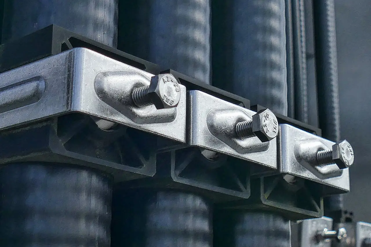 Detailed macro shot of metal bolts securing industrial machinery parts.